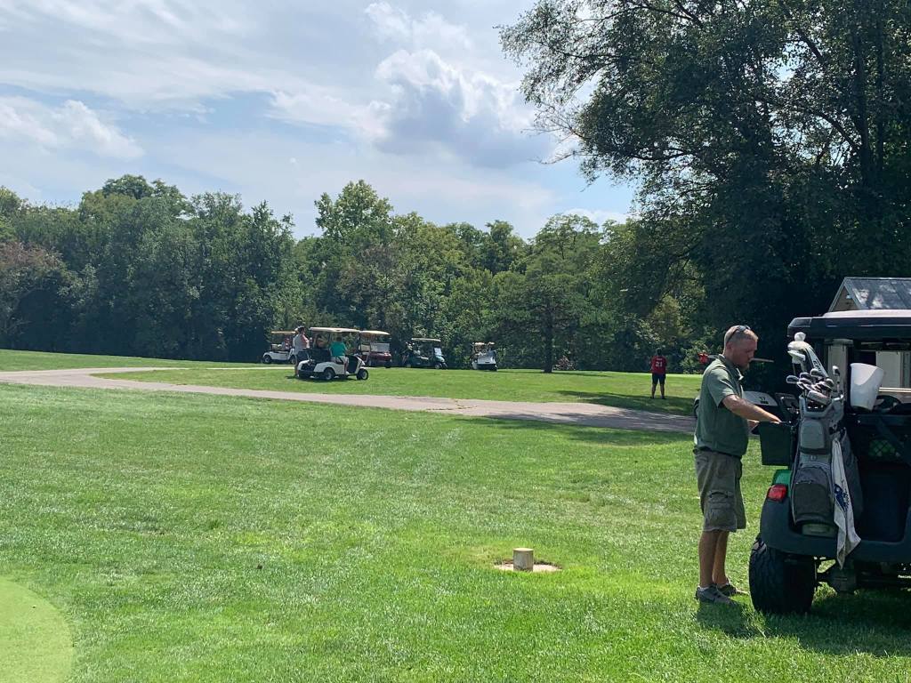 golfer next to this golf cart